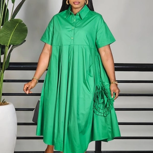 Detailed close-up of 3D floral ruffle accents on the side of a green A-line shirt dress