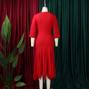 Detail view of red dress back with invisible zipper and elegant irregular wavy hemline