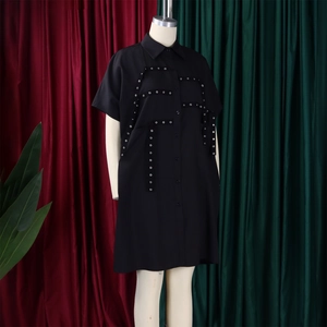Detailed view of black short sleeve shirt dress with metal eyelet strap design