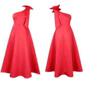Detail of red one-shoulder dress showing the large decorative bow and premium fabric texture