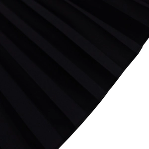 Macro detail of high-quality black pleated fabric with structured vertical accordion texture
