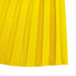 Close-up of vibrant yellow pleated dress fabric featuring precise vertical folds and hem detail