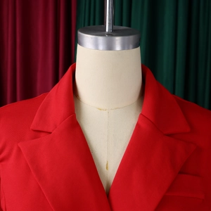Detail of red blazer dress showing notch lapels, shoulder pads, and woven fabric texture