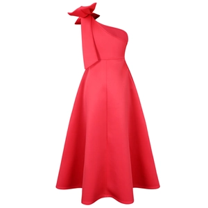 Detail of a red one-shoulder dress with a large decorative bow on the shoulder
