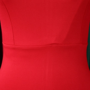 Close-up of red knit dress showing high-waisted seam and premium fabric texture