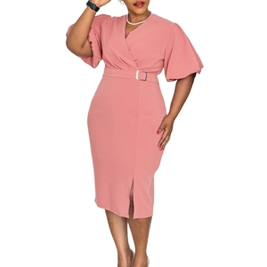 Detail of pink V-neck dress with belted waist, puffed sleeves and front leg slit