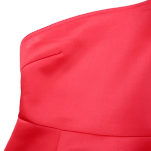 Detailed close-up of premium red fabric stitching and shoulder craftsmanship on evening dress