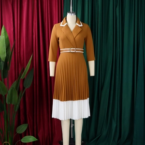 Detail of A-line pleated dress featuring lapel collar and waist belt on a mannequin