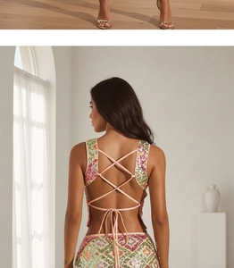 Close-up of pink criss-cross lace-up back design on a colorful sequin party outfit