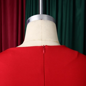Detail view of the hidden back zipper on this elegant red dress with smooth fabric texture