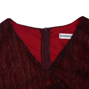 Macro detail of wine red pleated dress showing V-neck and branded back zipper