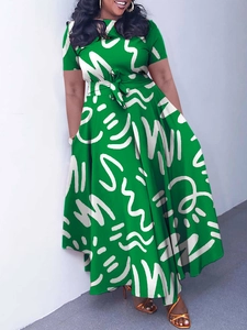 Short sleeve bright green African print dress with waist tie and A-line silhouette