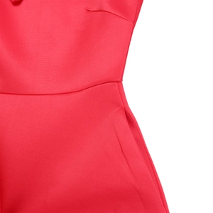 Detailed macro view of the red one-shoulder dress showing woven texture and side pockets