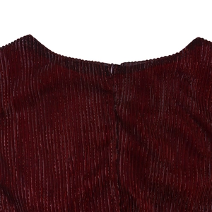 Detail of burgundy accordion pleat fabric with hidden back zipper on elegant V-neck dress