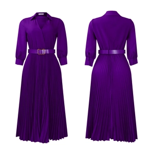 Detail of deep purple pleated maxi dress featuring a V-neck and matching buckled waist belt