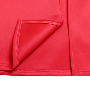 Detail of red dress stitching with neat hemline and split design in luxury knit fabric
