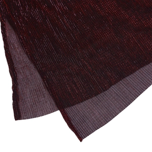 Detail of burgundy evening dress featuring metallic glitter fabric and pleated texture