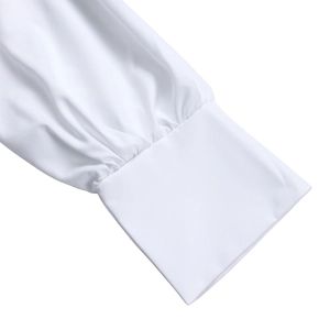 Detailed macro view of pleated white shirt cuffs with elegant wide buttoned wrist design
