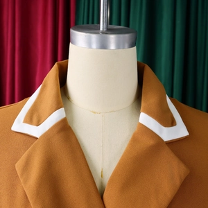 Detailed shot of a brown blazer notched lapel with white contrast piping details