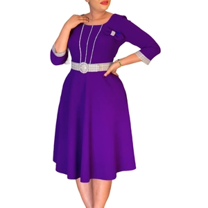 Detail of elegant purple dress showing bow buckle and chain accent on the shoulder