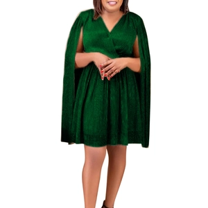 Detail of dark green V-neck dress featuring unique cape-style split sleeves and pleated texture