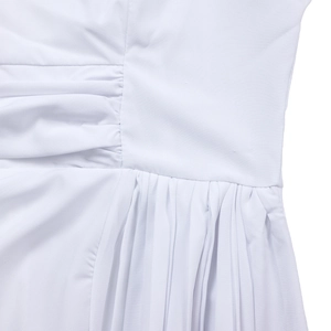 Detailed macro view of white dress fabric showing intricate ruching and pleated textures