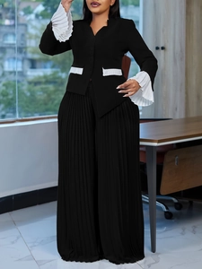 Women's plus size black business suit with white pleated cuffs and wide leg pants