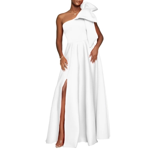 Detailed view of the elegant one-shoulder white gown featuring a large bow and side slit