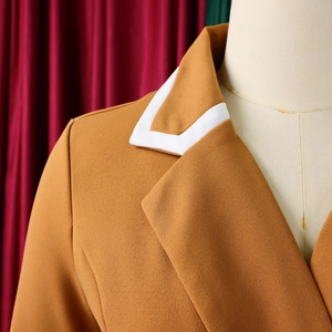Detail of tan blazer with white contrast piping on lapels displayed on a mannequin