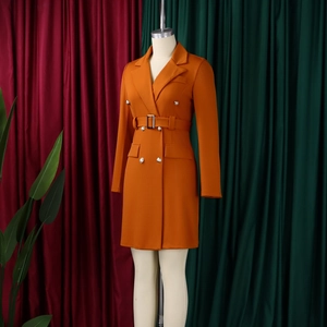Detail of double-breasted orange blazer dress with silver buttons and waist belt