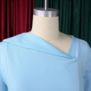 Detail of light blue asymmetric collar design on an elegant knit dress for women