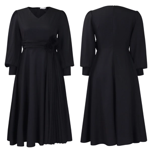 Detail of elegant black V-neck dress featuring 3D flower waist and pleated skirt panel