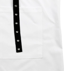 Detailed view of white shirt with a square patch pocket and black eyelet trim strap