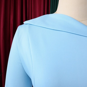 Detail of the elegant light blue dress showing asymmetrical collar and shoulder texture
