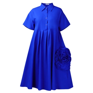 Detail of Klein blue shirt dress featuring a 3D fabric flower and pleated A-line skirt