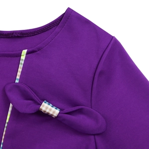 Detail of elegant round neckline with purple bow and plaid trim on stylish dress