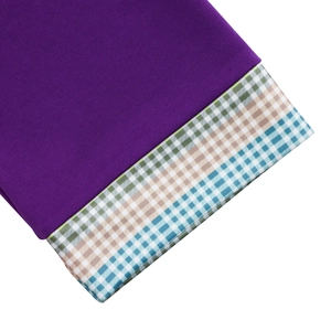 Close-up of elegant purple knit fabric with checkered pattern splicing detail on sleeves