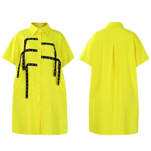Detailed flat lay of a yellow short sleeve shirt dress with black cross ribbons and eyelets
