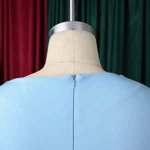 Detail showing the seamless back invisible zipper and textured fabric of the blue dress