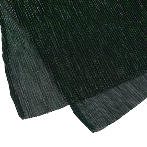 Detailed macro view of the dark green pleated fabric showing fine texture and sheen
