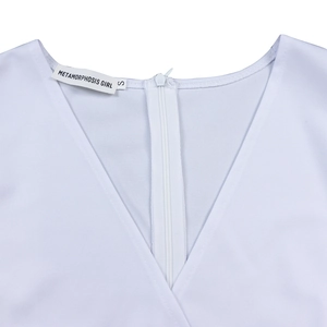 Close-up of V-neckline with METAMORPHOSIS GIRL brand label and zip detail on white dress
