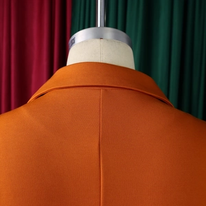 Macro shot of orange blazer dress back view showing collar detail and quality fabric