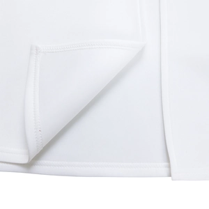 Detailed close-up showing double-needle stitching and hem finish on the white dress fabric