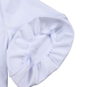 Detail shot of the elastic pleated cuffs on the white V-neck puff sleeve African dress