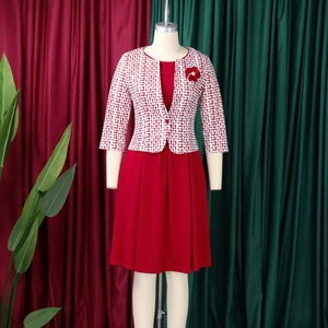 Détails de robe rouge sans manches avec cardigan géométrique et broche fleurie