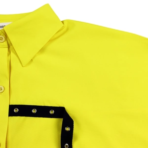 Detailed macro view of yellow lapel shirt with black webbing and silver metal eyelets