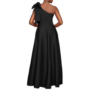 Elegant black one-shoulder evening gown featuring a large bow detail and long flowy skirt