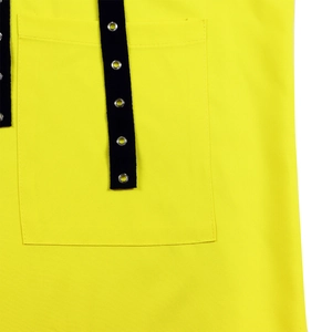 Detail of yellow cotton shirt featuring a cargo pocket with black straps and metal eyelets