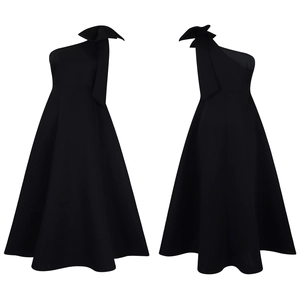 Detail of the elegant black one-shoulder dress featuring a large stylish bow on the shoulder