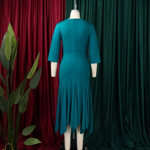 Detail view of teal slim-fit dress with back zipper and irregular fishtail hemline